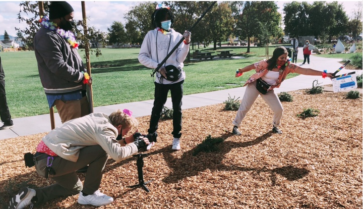 Cast and crew filming a scene